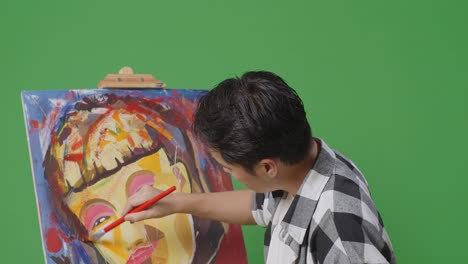 person painting a colorful portrait