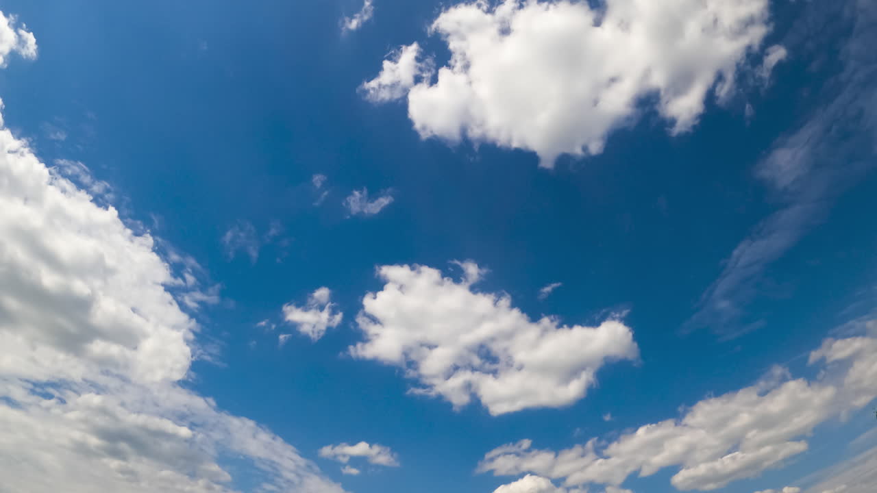 Amazing summer sky with soft fluffy clouds. Stratus cloudscape flying at backdrop. Low angle view. Timelapse.