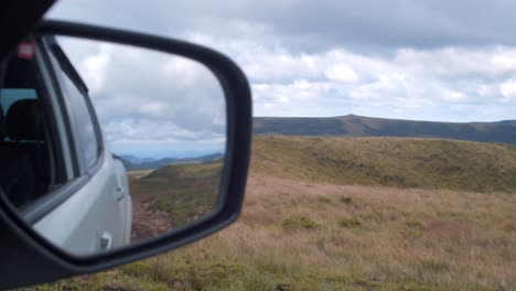 chapada dos guimarães national park, mato grosso, brazil - a glimpse of the véu da noiva plateau reflected in the side mirror of a car - close up