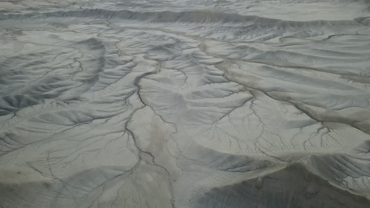 Drone flying over dry desert, landscape, and mountains in Utah