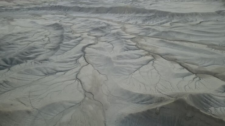 Drone flying over dry desert, landscape, and mountains in Utah