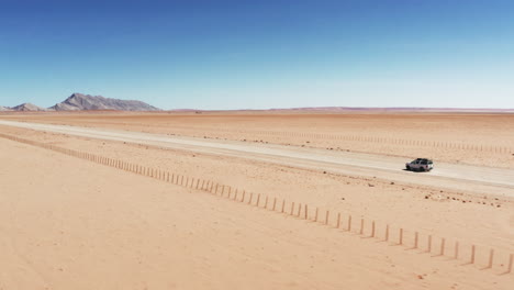 4x4-Jeep-Driving-Across-Wide-Desert-In-Namibia-On-A-Hot-Weather