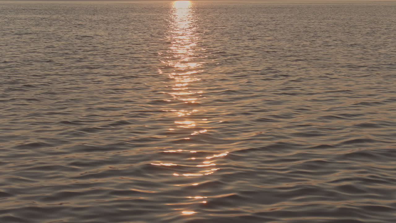 view from a yacht of a greek island at sunrise