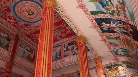 colorful religious paintings on the interior of pha that luang golden stupa buddhist temple in vientiane, laos