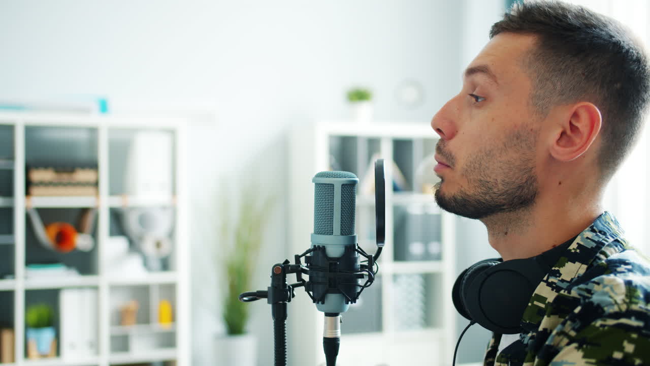 Man Singing Into Microphone in Home Studio