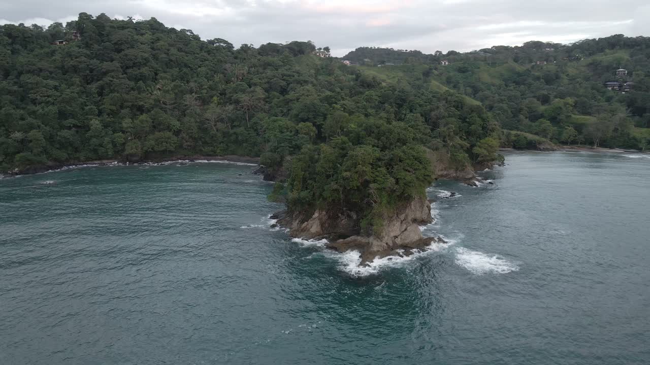 Drone orbiting around a small tropical peninsula at Costa Rica's pacific coast