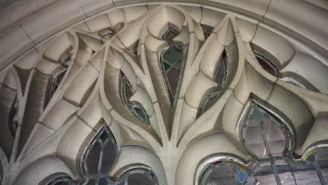 camera pans left to right over leaded glass window and tracery