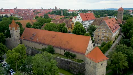 4k aerial drone video of the reichsstadthalle event venue on the town wall of rothenburg, germany