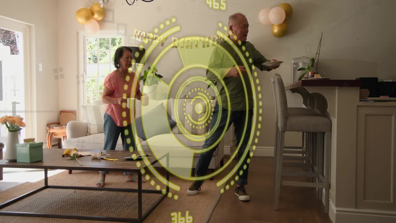 Couple tidying home living room after birthday, HUD overlay highlighting plates mug and gift