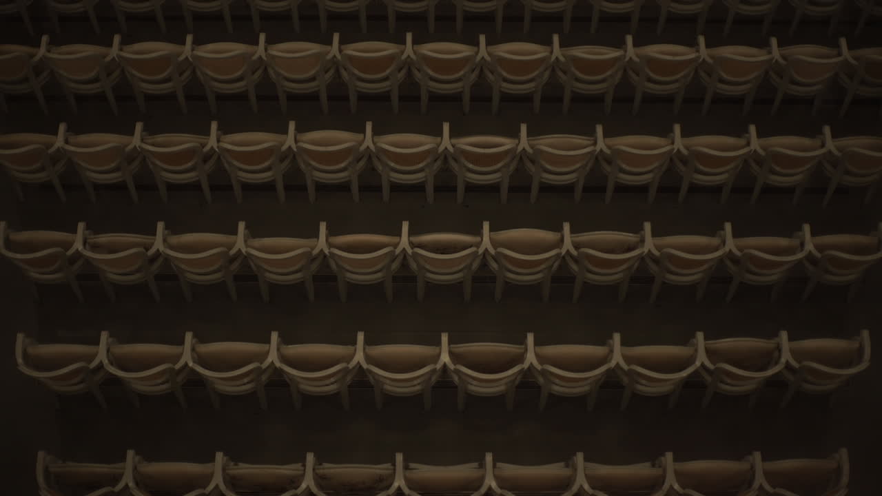 Top shot of empty concert hall chairs in retro colors