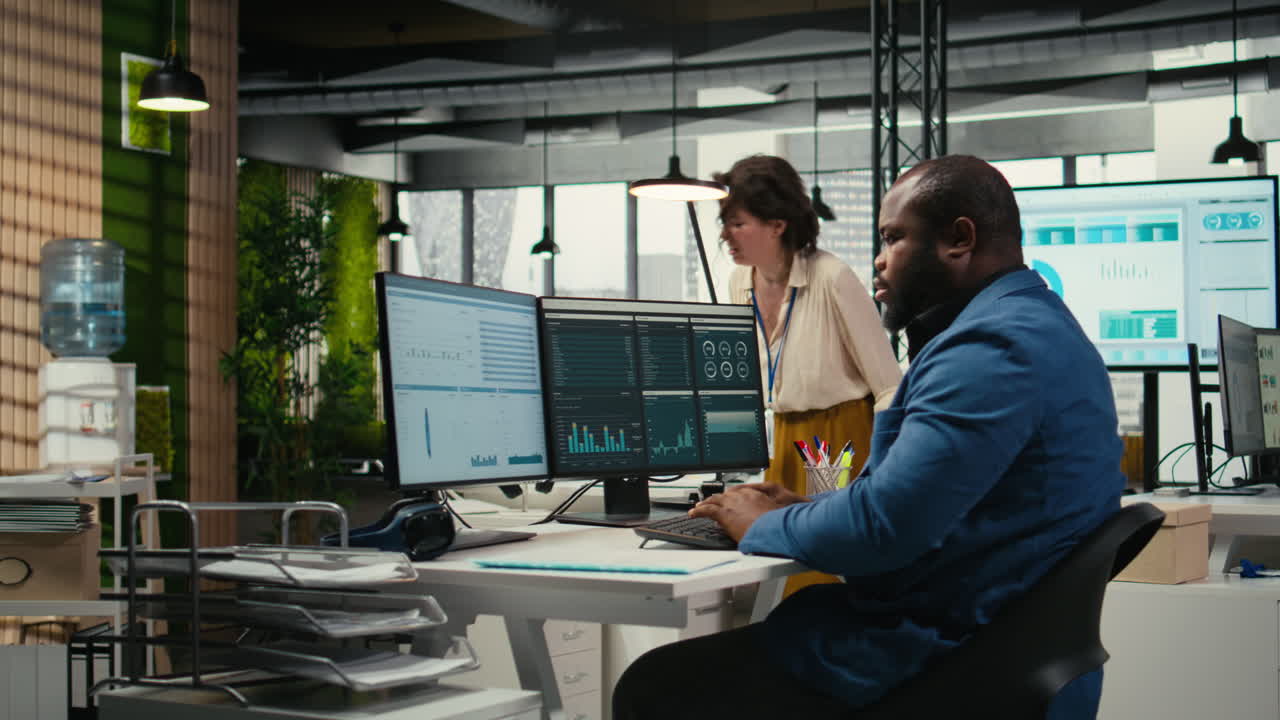 Vertical Video Black male administrator in modern workspace analyzing forecast insights