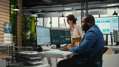 vertical video black male administrator in modern workspace analyzing forecast insights