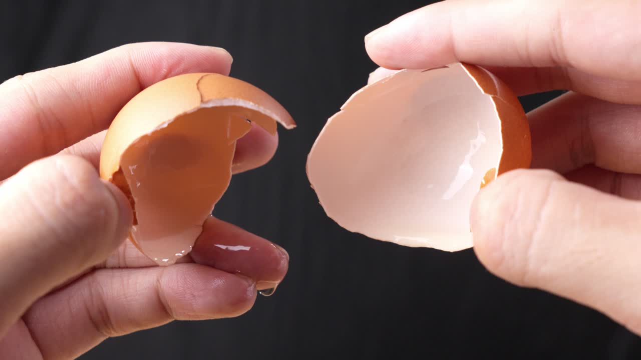 Close Shot Chef Hands Opening Raw Egg and Removing Yolk Macro Studio Shot