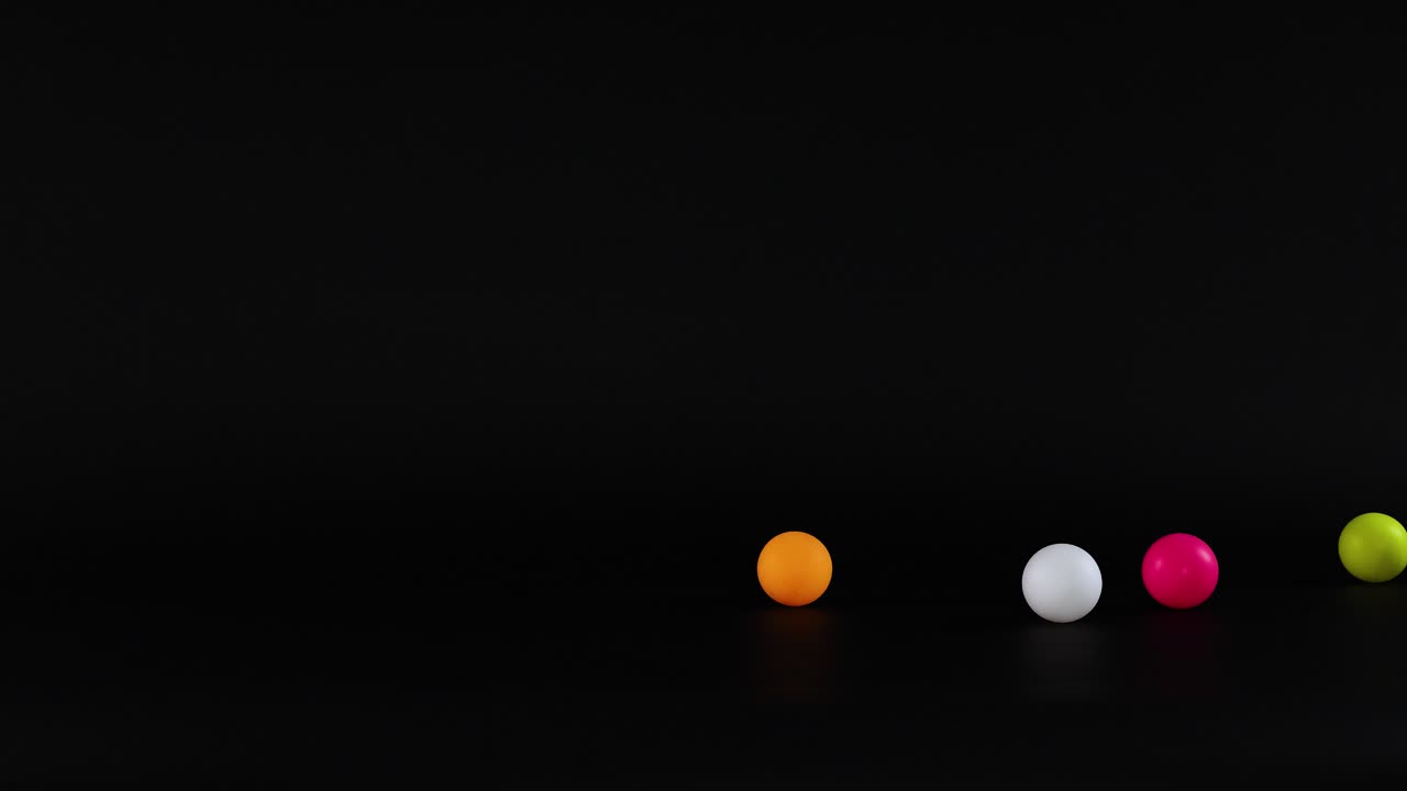 Vibrant balls moving across a dark background