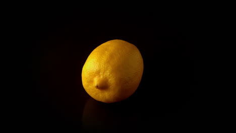 Lemon-spinning-on-black-surface