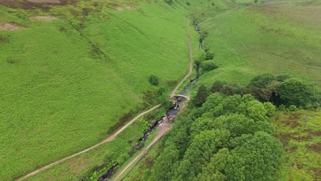 Aerial-shot-of-three-shire-heads-at-Dane-Valley-way-surrounded-with-greenery-in-England-during-daytime