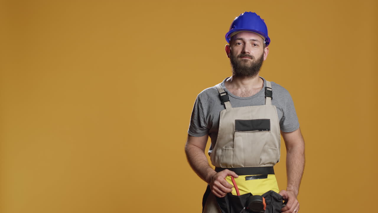Portrait of craftsman showing thumbs up gesture in studio