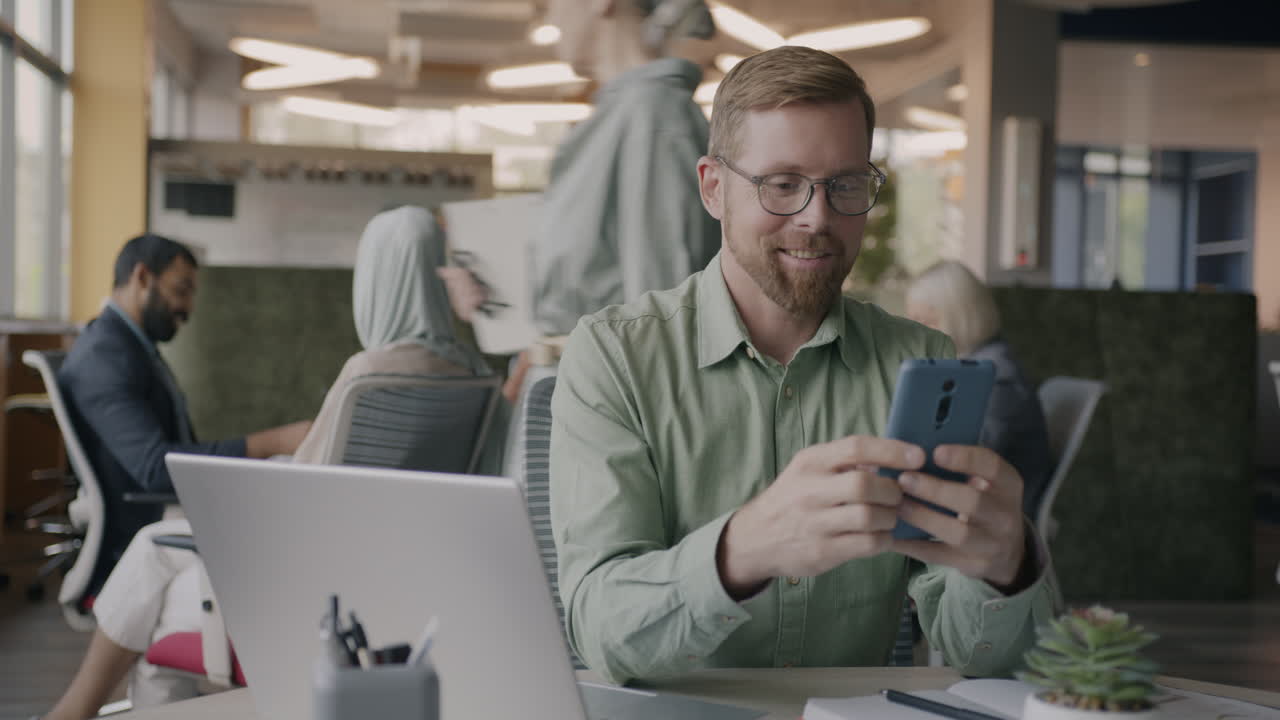 Business Person Using Smartphone in Office