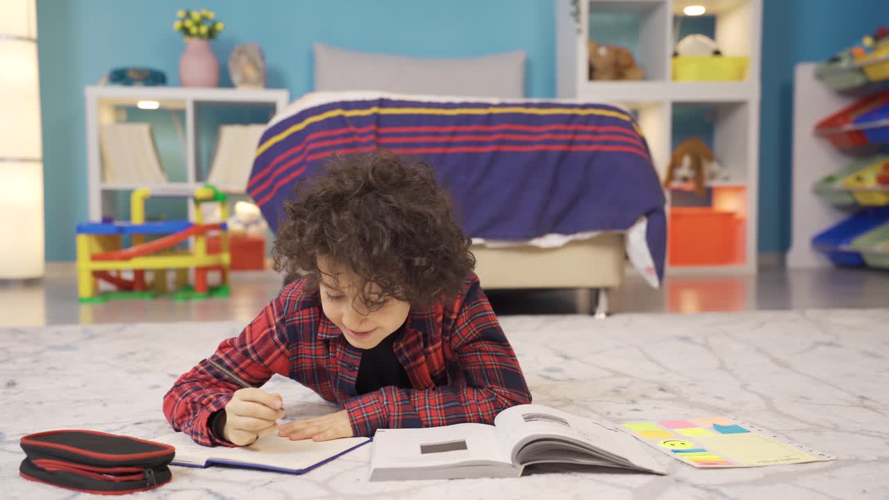 The boy is studying in the children's room.