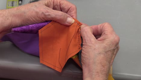 Woman-sewing-close-up-over-shoulder