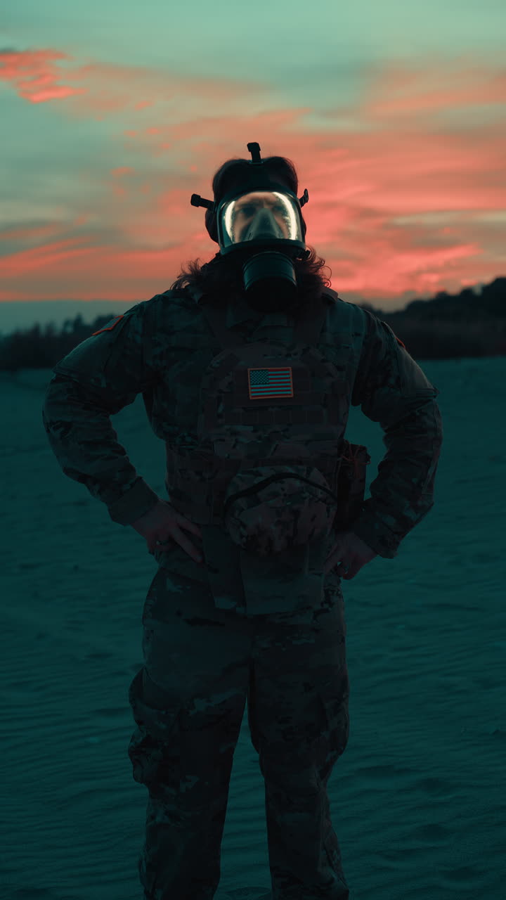American Soldier Wearing a Gas Mask on the Beach at Sunset, Ready Surveillance