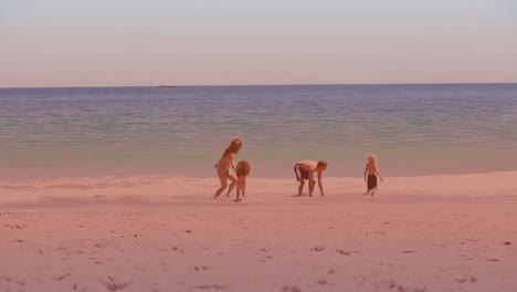 spots of light against caucasian family enjoying at the beach