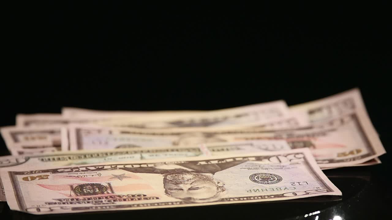 Jumping money On Moving Subwoofer on black background