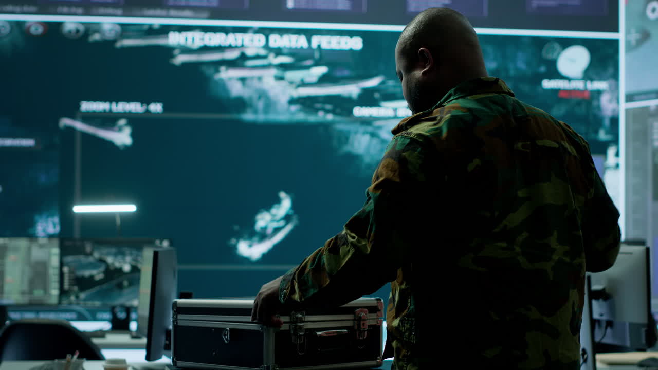 Army espionage specialist in a control center collecting satellite cctv data