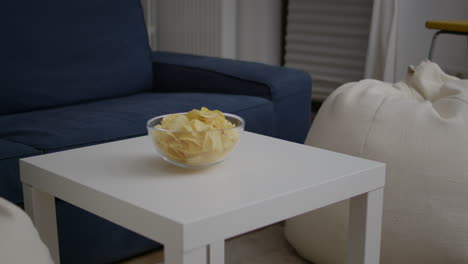 Closeup-of-junk-fried-potato-bowl-put-on-woden-table-in-empty-party-room