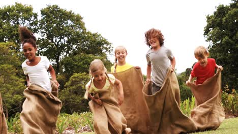 kids having a sack race in park