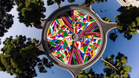 colorful circular mural on a street