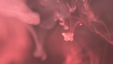 Abstraction-with-red-smoke,-steam-on-the-dark-background-with-light-going-through-it