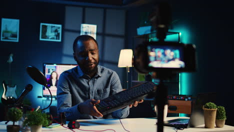 man reviews keyboard in apartment studio