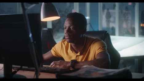 man working on computer at night