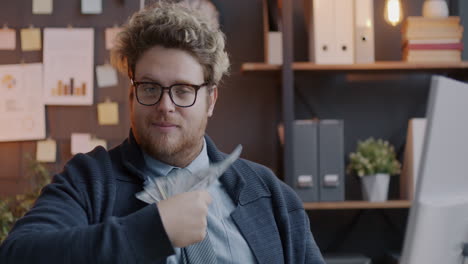 man holding money in office