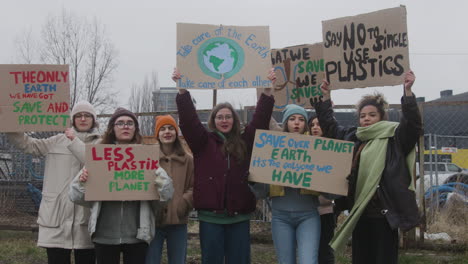 group of young female activists with banners protesting against climate change