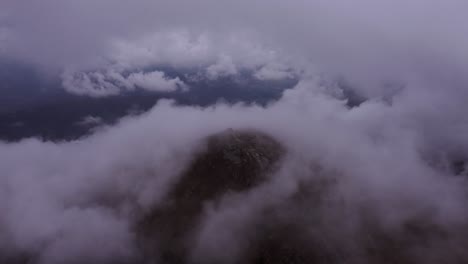 drone flying over the mountains and through the clouds