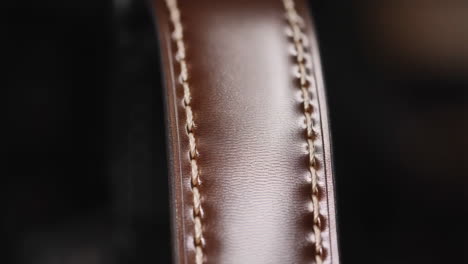 close-up of a brown leather strap with stitching