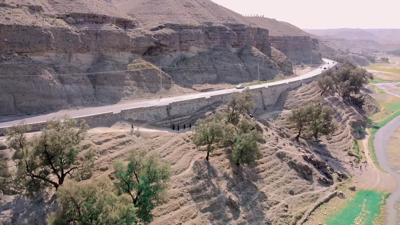 Kabul, Afghanistan. Drone Aerial View of Road Traffic and People by River in Landscape Outside of Country Capital