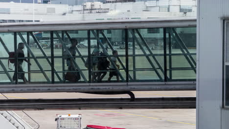 passengers exiting airplane using the sky bridge