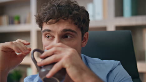 handsome entrepreneur thinking future success closeup. pensive man drink coffee