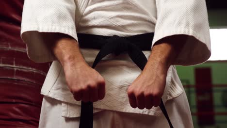 man practicing karate in fitness studio