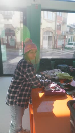 woman volunteering at a clothing donation center