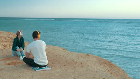 young people enjoying sea view and music