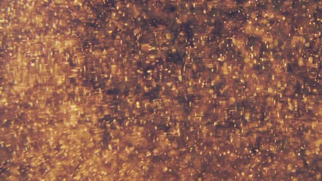 abstract golden particles with blurred defocused bokeh moves chaos, snow flakes