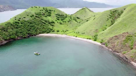 Drone establishing orbit of calm turquoise waters meeting green hills on a Costa Rica island, idyllic setting of hidden beauty
