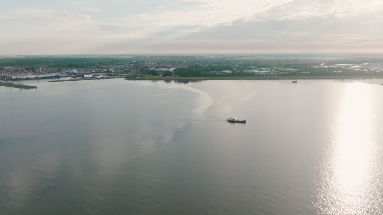 Aerial photo of the Dutch boat Luxemotor leaving the port of Urk in the province of Flevoland. Holland