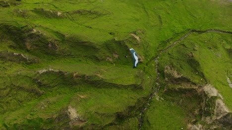 drone view above paraglider soaring over lush achill island terrain, ireland