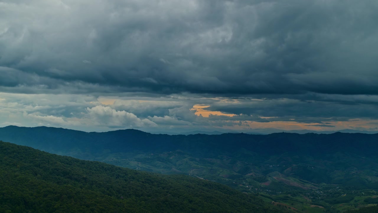 Stormy Clouds Moving Over Mountain Range at Sunset