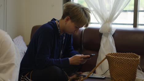 person sitting on couch using a smartphone